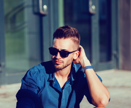 Fashionable man in a summer shirt and sunglassesの写真素材