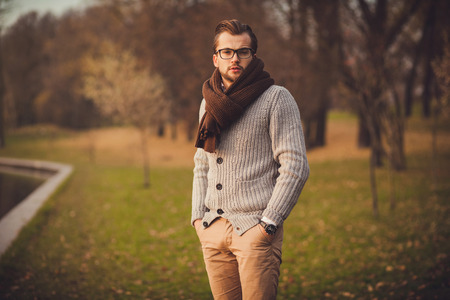 young attractive man in cardigan and glassesの写真素材