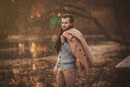 Trendy model man posing in parkの写真素材