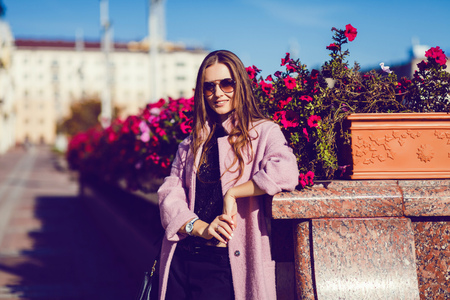 Pretty spring woman in city near flowers. copyspaceの写真素材