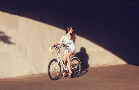 beautiful woman with a bicycle in an urban environment. lifestyleの写真素材