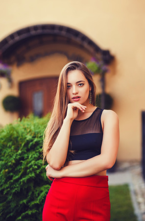 Fashionable woman model posing on street wearing stylish clothesの写真素材