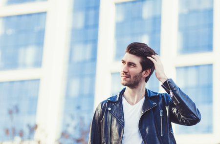 Portrait of a handsome fashion man in a black leather jacketの写真素材