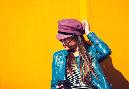 Stylish beautiful girl on yellow backgroundの写真素材
