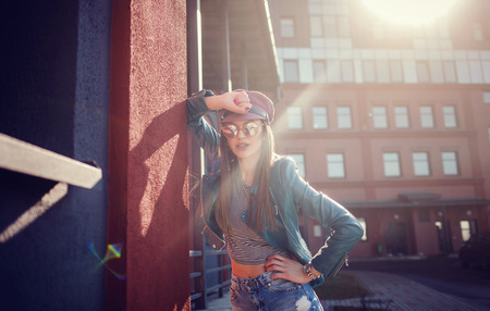 Cheerful young woman in sunglasses and hat. Beautiful female model with long hair.の写真素材
