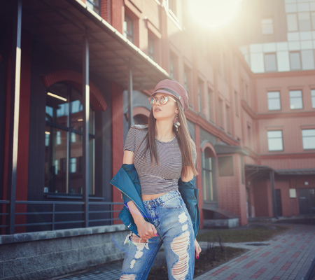 portrait fashion model in a leather jacket and sunglasses in an urban settingの写真素材