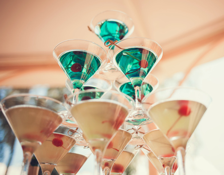 colorful pyramid of martini glasses with olivesの写真素材