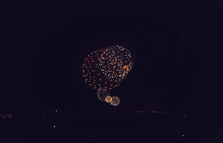 Orange amazing fireworks in dark background with the place for text. Happy New Year.の写真素材