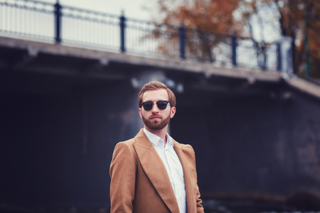 Portrait of young handsome stylish man in elegant coat.の写真素材