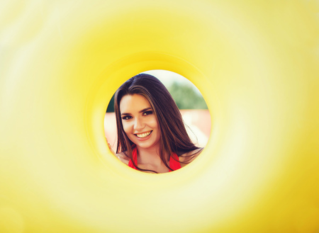 summer concept - smiling woman holding yellow inflatable circle in her handsの写真素材