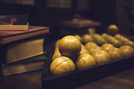 Billiard balls on a billiard table with books
