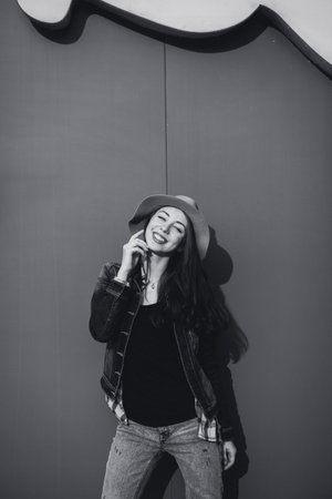 black and white portrait of a young positive woman outdoors