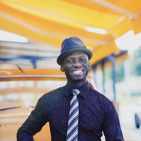 Portrait of handsome smiling afro man in cityの写真素材