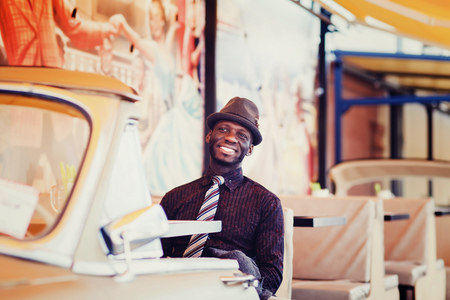 african american man in suit sitting in cafeの写真素材
