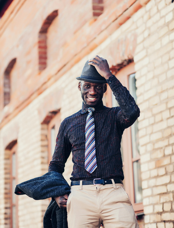 portrait of a happy african american guy in hatの写真素材