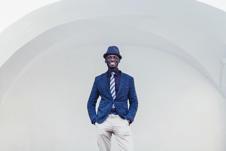 fashionable african man in suit with tie and hatの写真素材