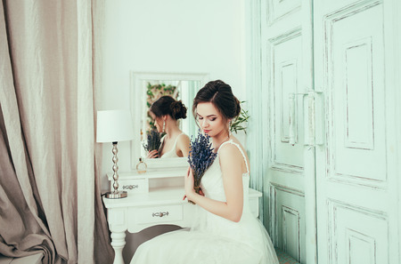 Gorgeous beauty young bride portrait. Beautiful bride with wedding makeup and jewelry. Fashion model posing in interior.の写真素材