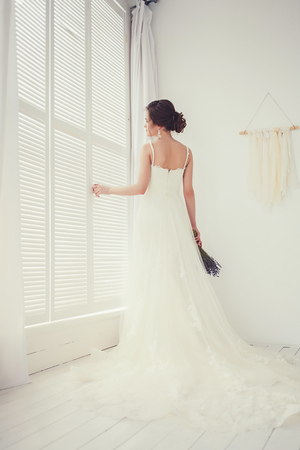bride's back in wedding dress with a bouquetの写真素材