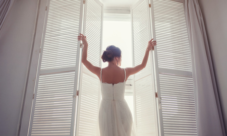 Portrait of the beautiful bride against a window indoorsの写真素材