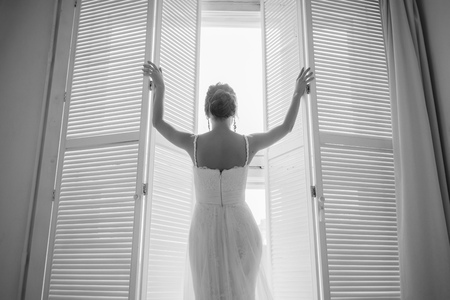 black and white portrait of the bride at the windowの写真素材