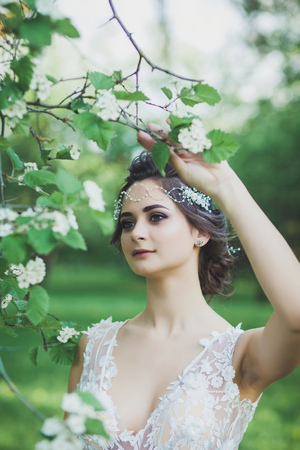 gentle portrait of a beautiful bride in a spring parkの写真素材
