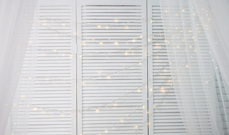 white wood wall christmas background with shiny lightsの写真素材