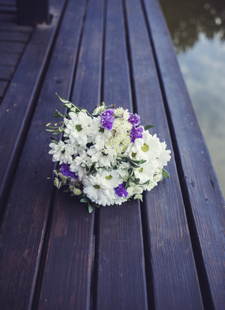 beautiful wedding bouquet on a wooden surfaceの写真素材