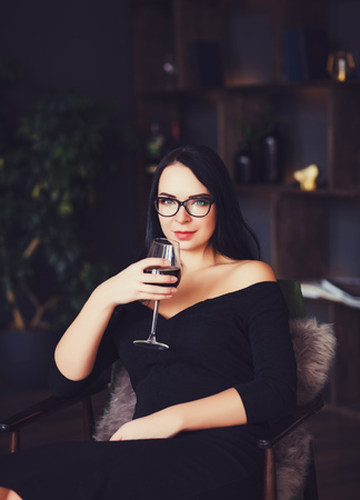 Attractive woman with the red lips, fault holding a glass.の写真素材