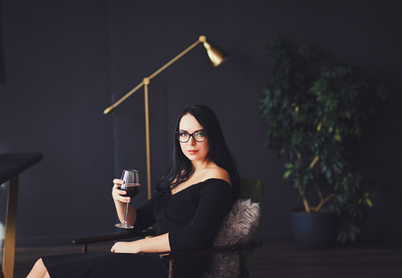 Beautiful woman with stylish make-up in black dressの写真素材