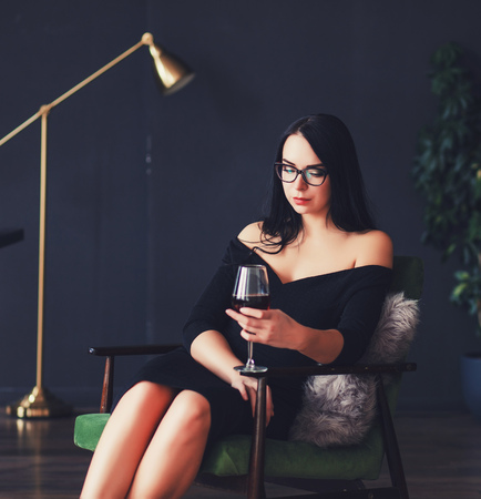 Portrait of the beautiful woman with glass of wineの写真素材
