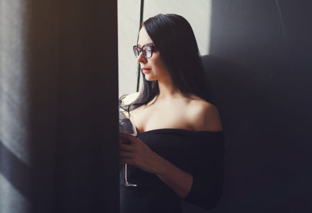 Portrait of serious young beautiful woman in hotel lobby. Beautiful business woman concept.の写真素材