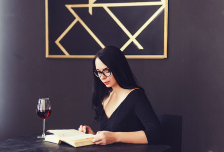 business lady sitting in a cafe reading a bookの写真素材
