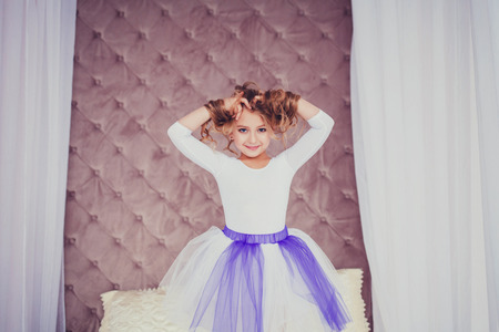 Pretty young girl in skirt posing in studioの写真素材
