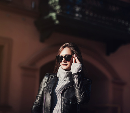 Fashion pretty woman in black leather jacket and sunglassesの写真素材
