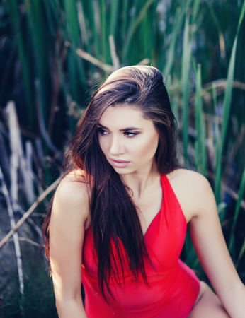 lifestyle portrait of sexy brunette woman getting sunbathe and having funの写真素材