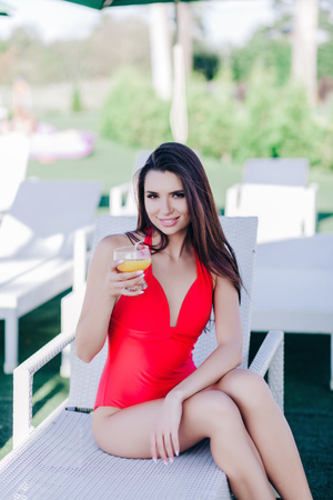 Portrait of relaxing happy woman with glass of cocktailの写真素材