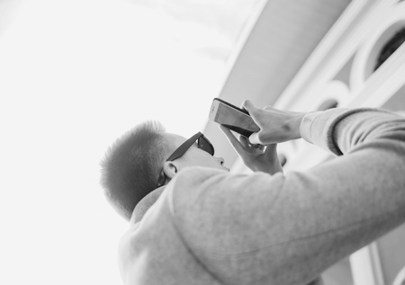 Man photographing with mobile smartphone cityの写真素材