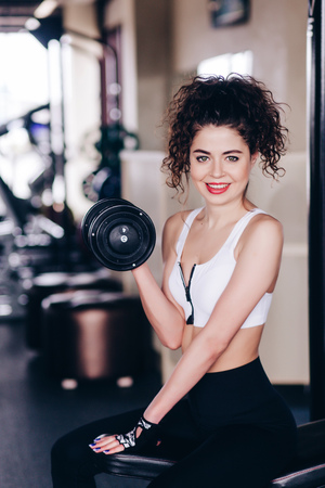 Sexy athletic girl working out in gym. Fitness woman doing exercise.の写真素材