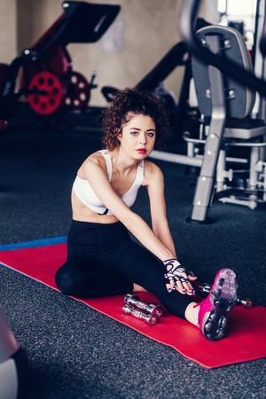Young sporty woman in stretching at gym.の写真素材