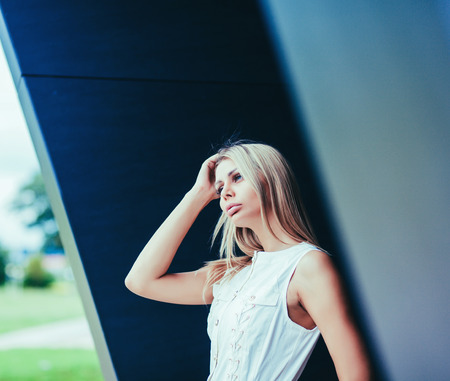 Beauty blonde young woman in white dressの写真素材
