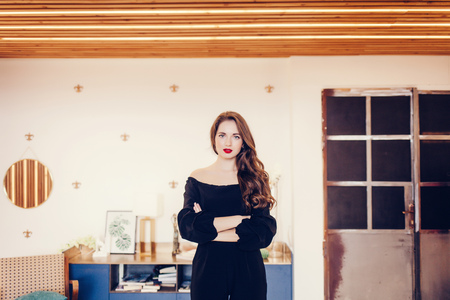 Attractive young woman posing in a room with modern interior. Beauty, fashion. Evening makeup and hairstyle.の写真素材