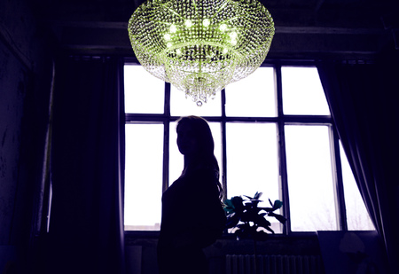 Mysterious Woman. Mystery girl silhouette on window backgroundの写真素材