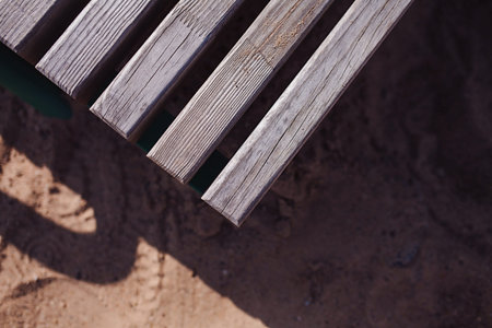 Corner of old wooden table or bench as its background