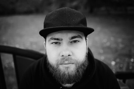 Bearded man in hat black and white portraitの写真素材