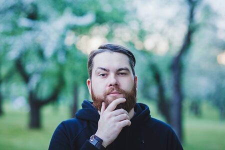 beautiful bearded man posing in outdoor Parkの写真素材