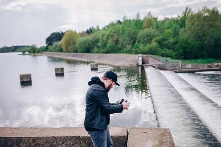 Man videographer makes videos of nature, rivers and landscapesの写真素材