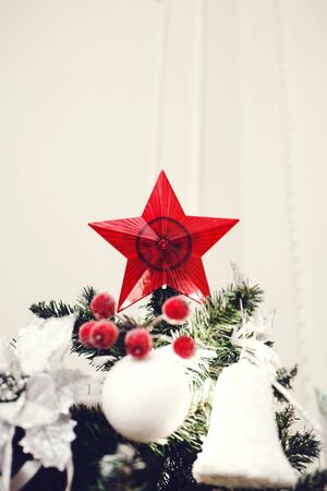Red star christmas decoration on christmas treeの写真素材