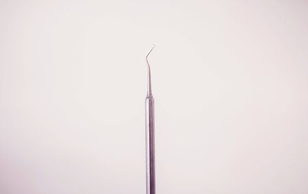 Dental instrument. Dental probe hook on backgroundの写真素材