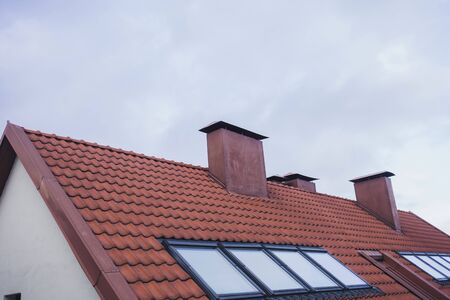 tiled roof with attic and chimney of the old townの写真素材