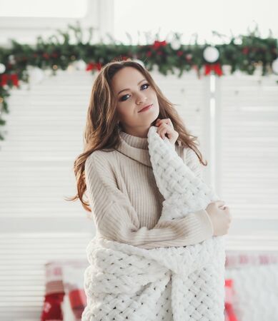 portrait of a lovely woman in a cozy apartmentの写真素材